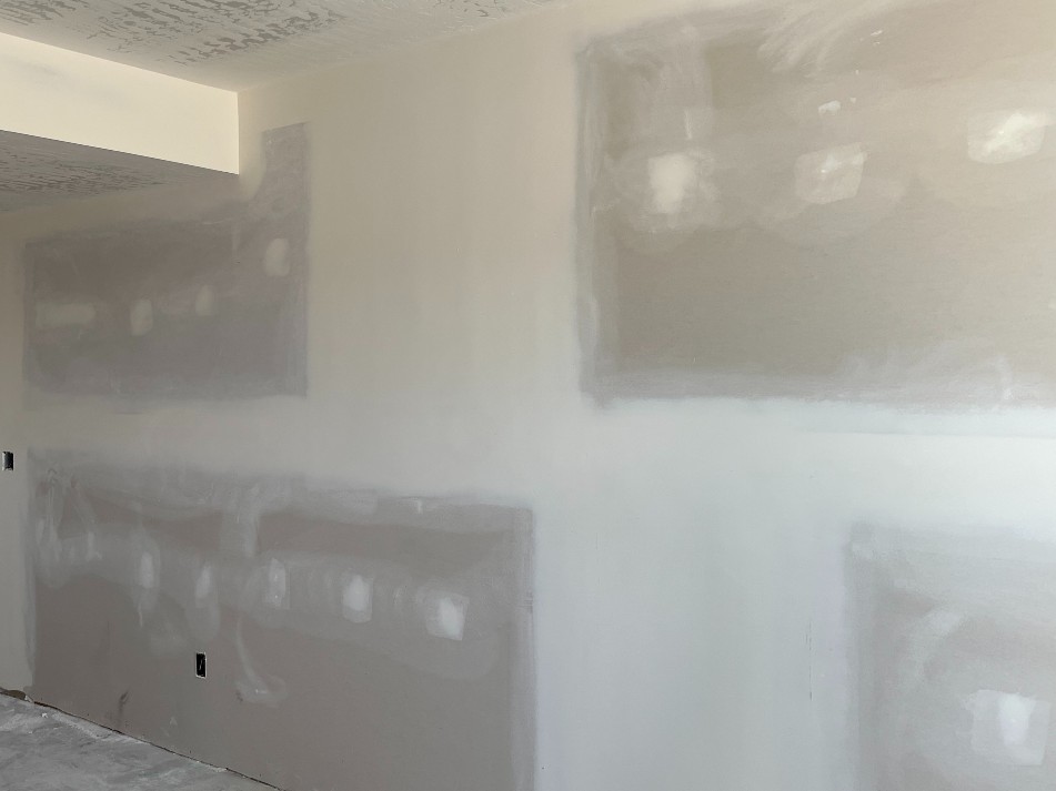 Image shows freshly sanded drywall ready for paint in Florida home